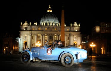 A vintage racing car passes by St. Peter's square as the historic Mille Miglia race arrives in Rome on May 15, 2009. The first open-road endurance race started in 1927 from Brescia to Rome and back, a figure-eight shaped course of roughly 1500 km - or a thousand Roman miles. This parade of classic machines has earned the Mille Miglia the reputation of being the the most beautiful road race in the world. (File photo: AFP)