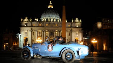 A vintage racing car passes by St. Peter's square as the historic Mille Miglia race arrives in Rome on May 15, 2009. The first open-road endurance race started in 1927 from Brescia to Rome and back, a figure-eight shaped course of roughly 1500 km - or a thousand Roman miles. This parade of classic machines has earned the Mille Miglia the reputation of being the the most beautiful road race in the world. (File photo: AFP)