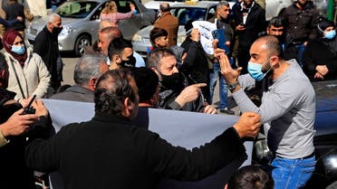 A man stuck in traffic argues with parents of Lebanese students who study abroad to reopen a road blocked during a protest demanding that banks allow the transfer of universities fees for their children, in Beirut, Feb. 22, 2021. (AP)