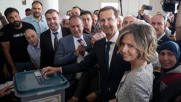 Syrian President Bashar Assad and his wife Asma vote at a polling station during the Presidential elections in the town of Douma, near the Syrian capital Damascus, Syria, May 26, 2021. (AP/Hassan Ammar)