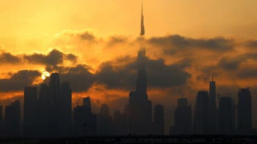 This picture taken on February 13, 2021 shows a view of the skyline of downtown Dubai with Burj Khalifa, at sunset. (AFP)