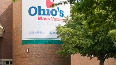 People walk past sign displayed for Ohio's COVID-19 mass vaccination clinic at Cleveland State University, Tuesday, May 25, 2021, in Cleveland. (AP)