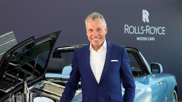 Torsten Muller-Otvos, CEO of Rolls-Royce, poses next to a handmade car described as 'the most refined picnic facility on earth,' at the company's factory in Goodwood, Britain May 27, 2021. (Reuters)