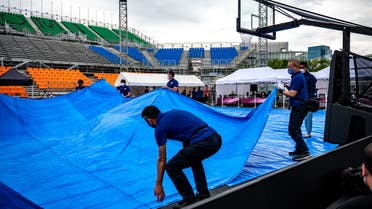 Staff members and volunteers prepare for a 3X3 basketball test event for the 2020 Tokyo Olympics at Aomi Urban Sports Park in Tokyo on May 16, 2021. (File photo: AFP)