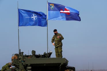 NATO and NATO’s Enhanced Forward Presence battle group Latvia flags flutter during military exercise Crystal Arrow 2021 in Adazi, Latvia, on March 26, 2021 (Reuters)
