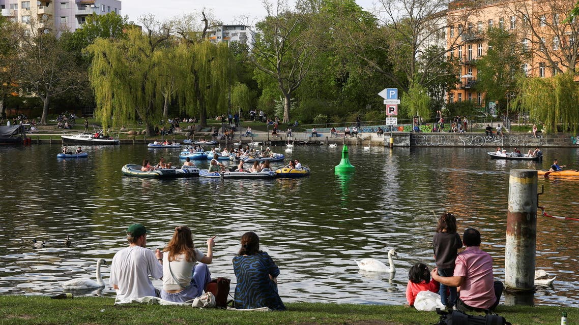People enjoy the sunny weather on the Landwehrkanal, as the spread of the coronavirus disease (COVID-19) continues, in Berlin, Germany, May 9, 2021. (Reuters)