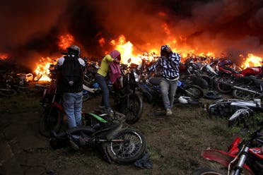 Motorcycles that are are impounded for violating traffic regulations are seen on fire at the municipal yards, in Popayan, Colombia May 28, 2021. (Reuters)