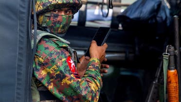 FILE PHOTO: A soldier uses a mobile phone as he sit inside a military vehicle outside Myanmar's Central Bank during a protest against the military coup, in Yangon, Myanmar, February 15, 2021. (File Photo: Reuters)