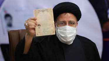 Ebrahim Raisi, Chief Justice of Iran, shows his identification document as he registers as a candidate for the presidential election at the Interior Ministry, in Tehran, Iran May 15, 2021. Majid Asgaripour/ WANA (West Asia News Agency) via REUTERS ATTENTION EDITORS - THIS IMAGE HAS BEEN SUPPLIED BY A THIRD PARTY.