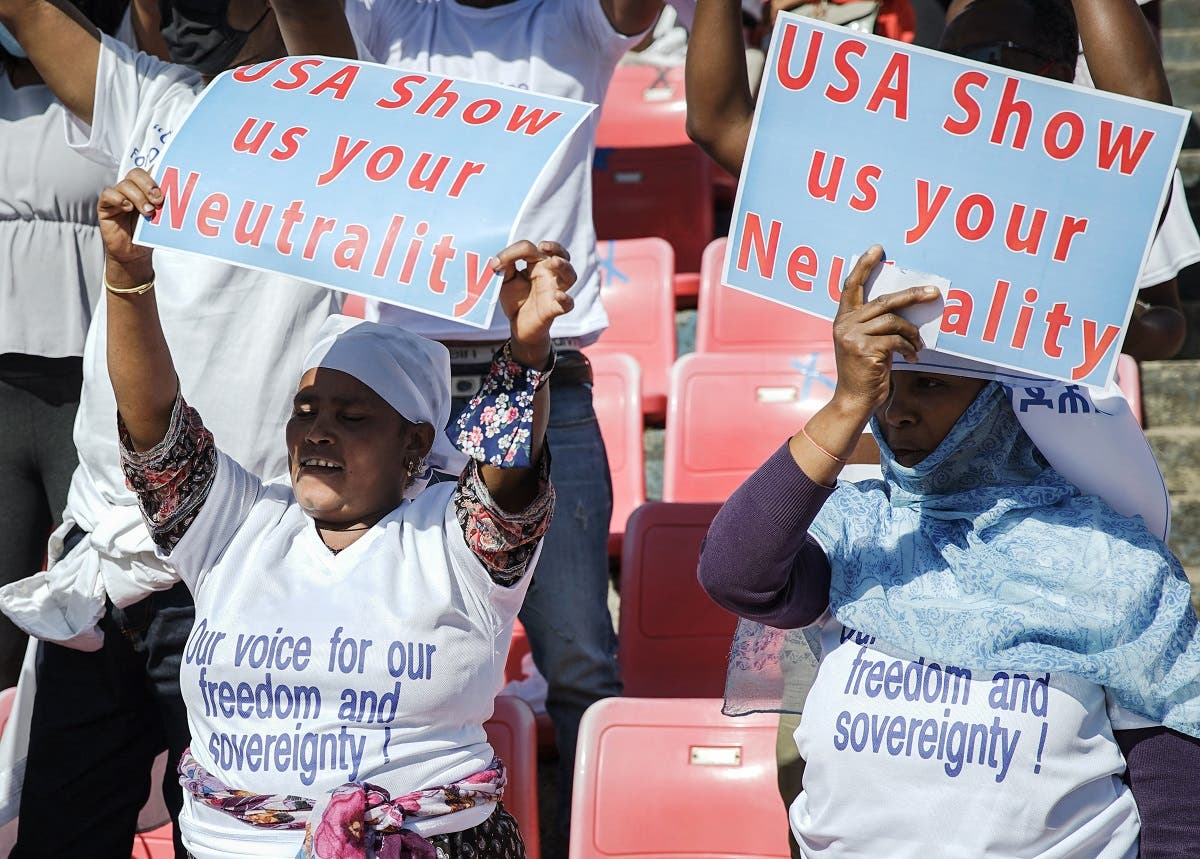 Protesters hold their messages during a massive rally to rail against the United States imposing restrictions on economic and security assistance over the conflict in the Tigray region at Addis Ababa soccer stadium in Addis Ababa, Ethiopia. (Reuters)