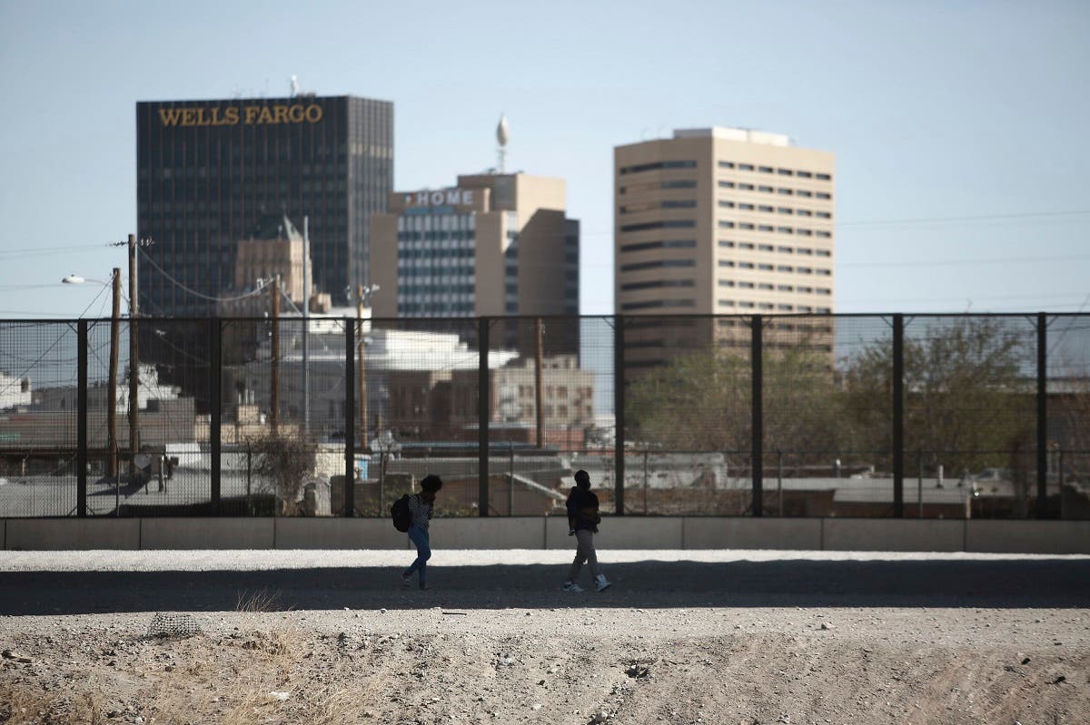 Migrants cross the border to surrender to US Border Patrol as seen from Ciudad Juarez, Mexico, March 23, 2021. (AP)