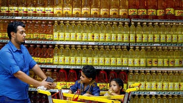 Shoppers are seen in an aisle with subsidised vegetable oils at a government outlet in Cairo. (Reuters)