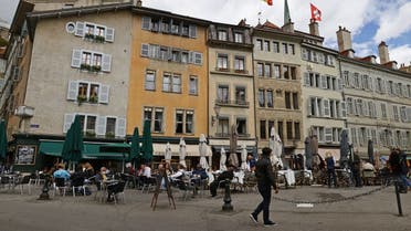 People eat on a terrace during easing of lockdown measures against the coronavirus outbreak in Geneva, Switzerland, on May 5, 2021. (Reuters)