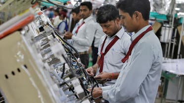 Employees of Motherson Sumi Systems Limited, work on a car wiring assembly line inside a factory in Noida on the outskirts of New Delhi, India. (File photo: Reuters)