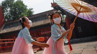 Children wearing protective face masks play near the entrance to the Forbidden City on the day of the opening of the National People's Congress (NPC) following the outbreak of the coronavirus disease (COVID-19), in Beijing, China May 22, 2020. (Reuters)