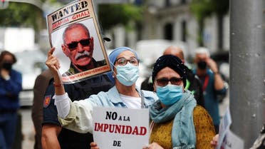 People hold placards as they protest against Brahim Ghali, Secretary General of the Polisario Front, outside Spanish High Court in Madrid, Spain, June 1, 2021. (Reuters)