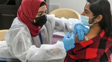 A woman receives a dose of a vaccine against the coronavirus disease (COVID-19)at St. Paul's Church in Abu Dhabi, United Arab Emirates January 16, 2021. (Reuters)