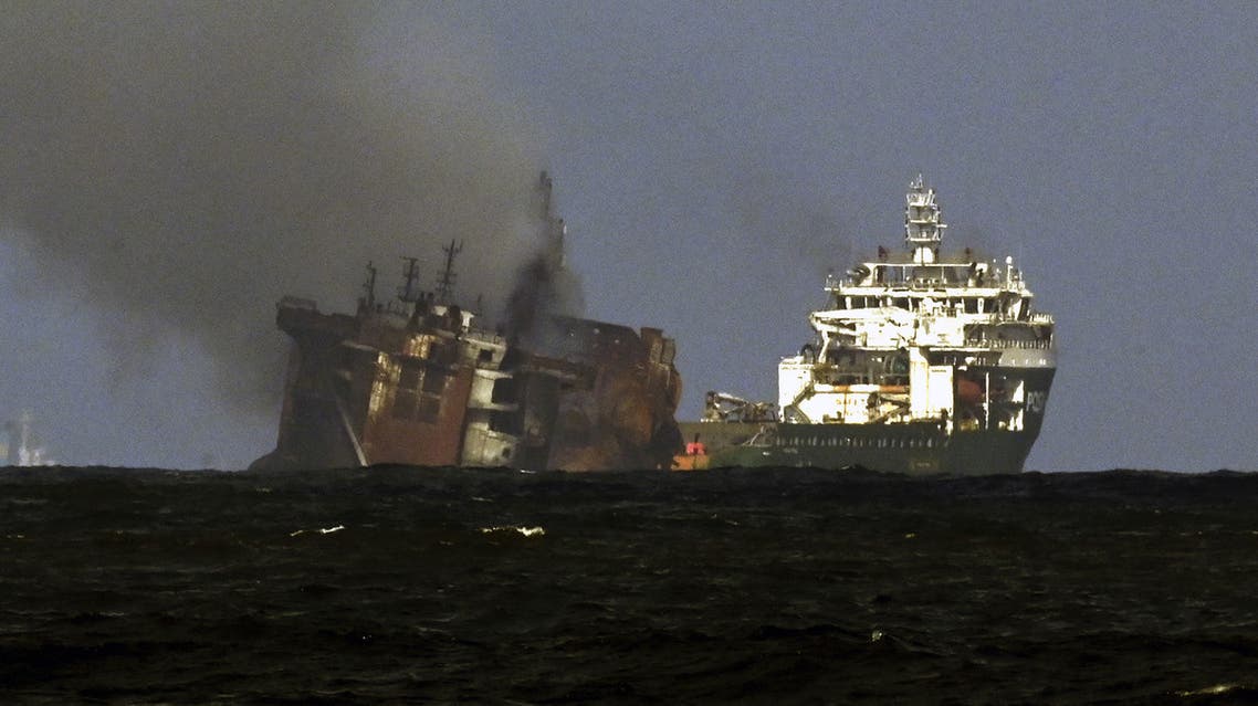 A tugboat (R) from the Dutch salvage firm SMIT tows the fire stricken Singapore-registered container ship MV X-Press Pearl away from the coast of Colombo on June 2, 2021 following Sri Lankan President Gotabaya Rajapaksa's order to move the ship to deeper water. (File photo: AFP)