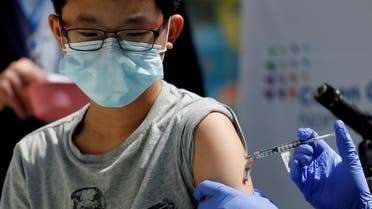 Brendan Lo (13) receives a dose of the Pfizer-BioNTech vaccine for the coronavirus disease (COVID-19) at Northwell Health's Cohen Children's Medical Center in New Hyde Park, New York, U.S., May 13, 2021. REUTERS/Shannon Stapleton