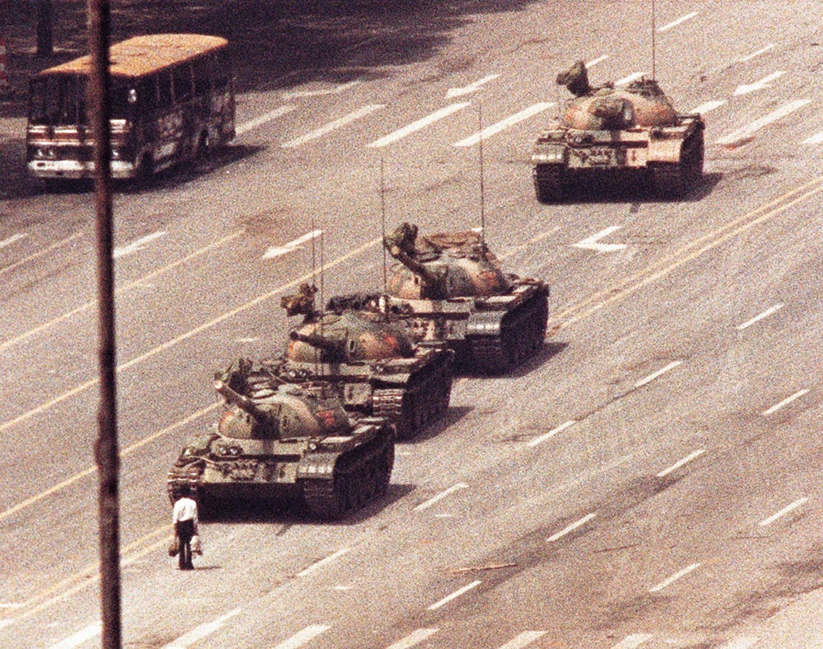 A man stands in front of a convoy of tanks in the Avenue of Eternal Peace in Tiananmen Square in Beijing in this June 5, 1989 file photo. (Reuters/Arthur Tsang /Files)