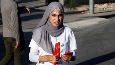 Palestinian activist Muna el-Kurd (C) takes part in a rally to demand the reopening of the Israeli Police checkpoint at the entrance of the Sheikh Jarrah neighborhood in east Jerusalem, on May 29, 2021. (Ahmad Gharabli/AFP)