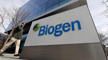 A man walks past the Biogen Inc., headquarters, Wednesday, March 11, 2020, in Cambridge, Mass. (AP/Steven Senne)