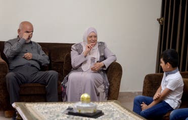 Grandparents of Aws Oudah, 5, talk to him through sign language at his home in Amman, Jordan June 2, 2021. Picture taken June 2, 2021. (Reuters)