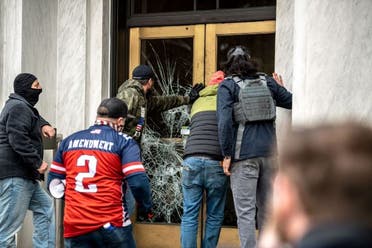 Far-right protesters break the door to the Capitol building during a protest against restrictions to prevent the spread of coronavirus disease (COVID-19) in Salem, Oregon, US, December 21, 2020. (Reuters)