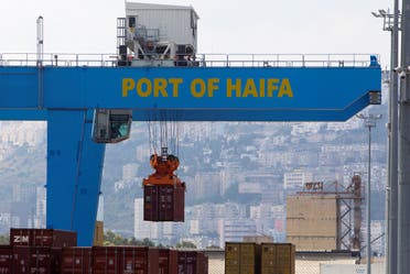 A crane unloads a container at the port of the northern city of Haifa, Israel. (Reuters)