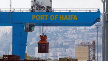 A crane unloads a container at the port of the northern city of Haifa, Israel. (Reuters)
