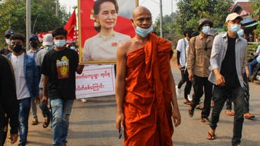 This handout photo taken and released by Dawei Watch on March 27, 2021 shows a Buddhist monk walking with protesters, as a portrait of detained civilian leader Aung San Suu Kyi is held aloft, during a demonstration against the military coup in Dawei. (File photo: AFP)