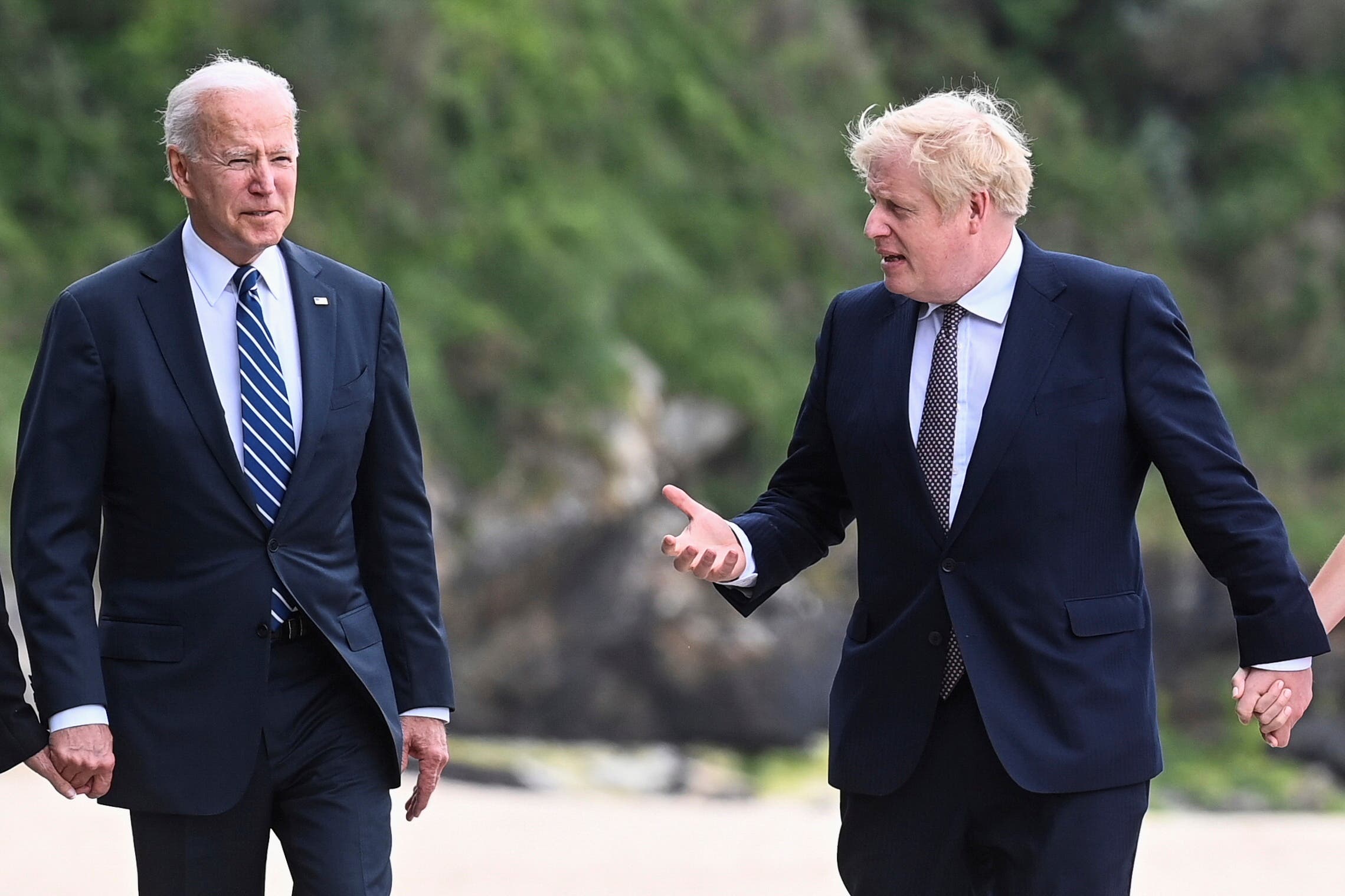  US President Joe Biden, left, talks with Prime Minister Boris Johnson, during a walk, with their wives (not pirctured) outside Carbis Bay Hotel, Carbis Bay, Cornwall, Britain, ahead of the G7 summit, Thursday June 10, 2021. (AP)