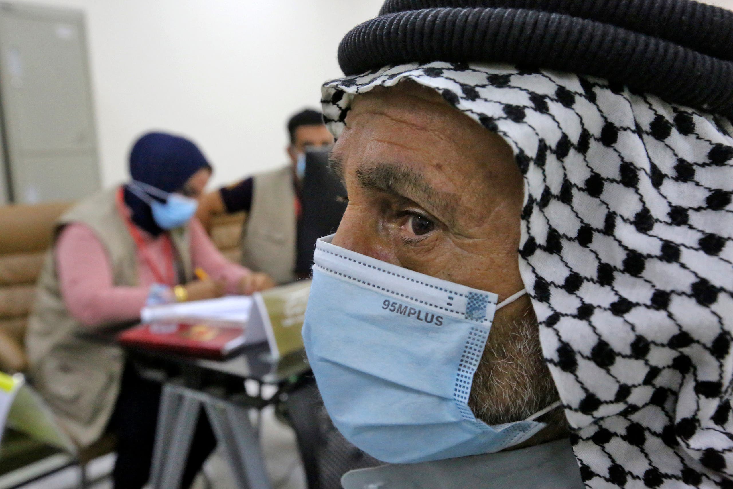 families of Iraqis whose bodies were found in mass graves in the village of Badush, northwest of the city of Mosul, when it was in the hands of the Islamic State group, wait to give blood to Iraqi forensic experts to match with the remains of their loved ones for identification, on June 9, 2021 in Baghdad. (AFP)