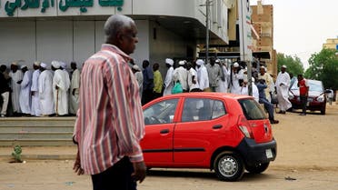 Sudanese customers queue to access money services at the Faisal Islamic Bank (Sudan) in Khartoum. (Reuters)