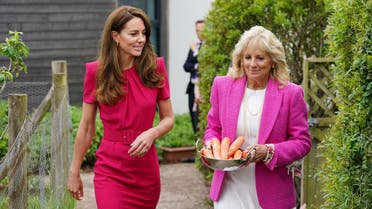 Britain's Kate, Duchess of Cambridge, left, and US First Lady Jill Biden, carrying carrots for the school rabbit, Storm, during a visit to Connor Downs Academy in Hayle, West Cornwall, during the G7 summit in England, Friday, June 11, 2021. (AP)