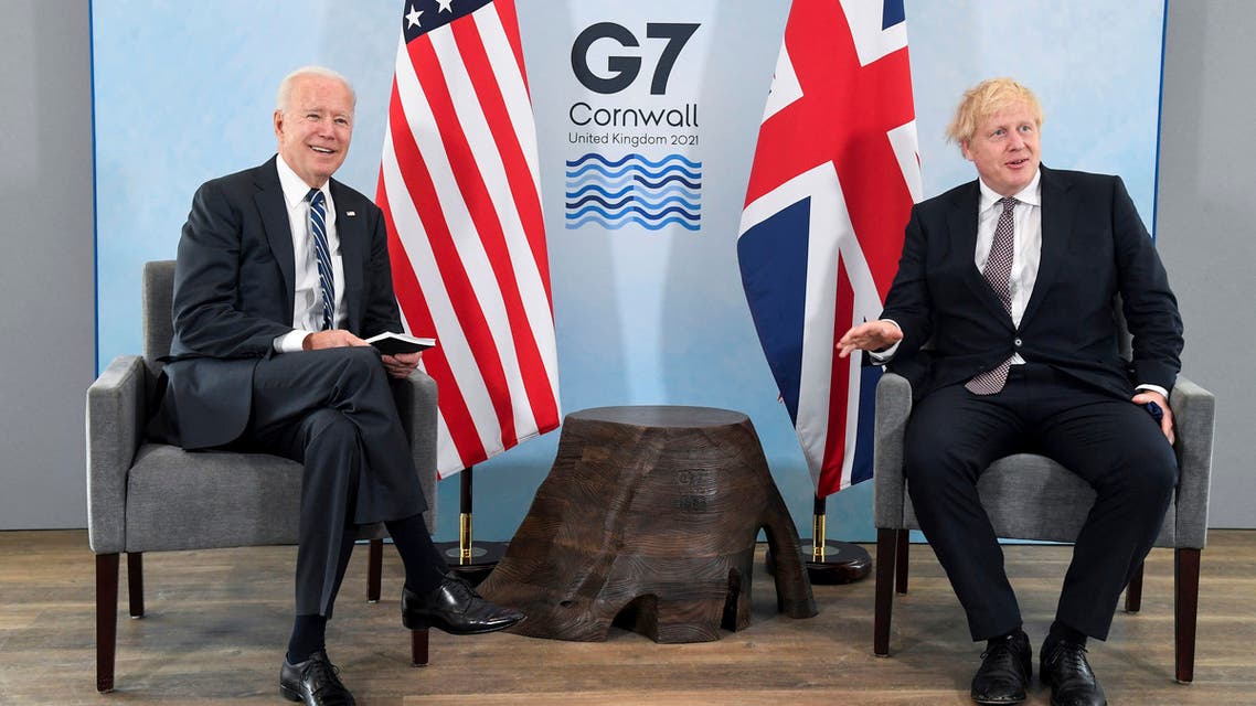 US President Joe Biden, left, poses for a photo with Britain's Prime Minister Boris Johnson, during their meeting ahead of the G7 summit in Cornwall, Britain, Thursday June 10, 2021. (AP)