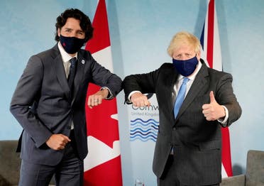 Britain's Prime Minister Boris Johnson and Canada's Prime Minister Justin Trudeau elbow bump prior to a bilateral meeting during the G7 summit in Carbis Bay, Cornwall, Britain, June 11, 2021. (Reuters)