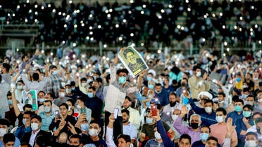  In this Wednesday, June 9, 2021 photo, a supporter of the presidential candidate Ebrahim Raisi, currently judiciary chief, hold his posters during a campaign rally at the Takhti Stadium in Ahvaz, Iran. (AP)