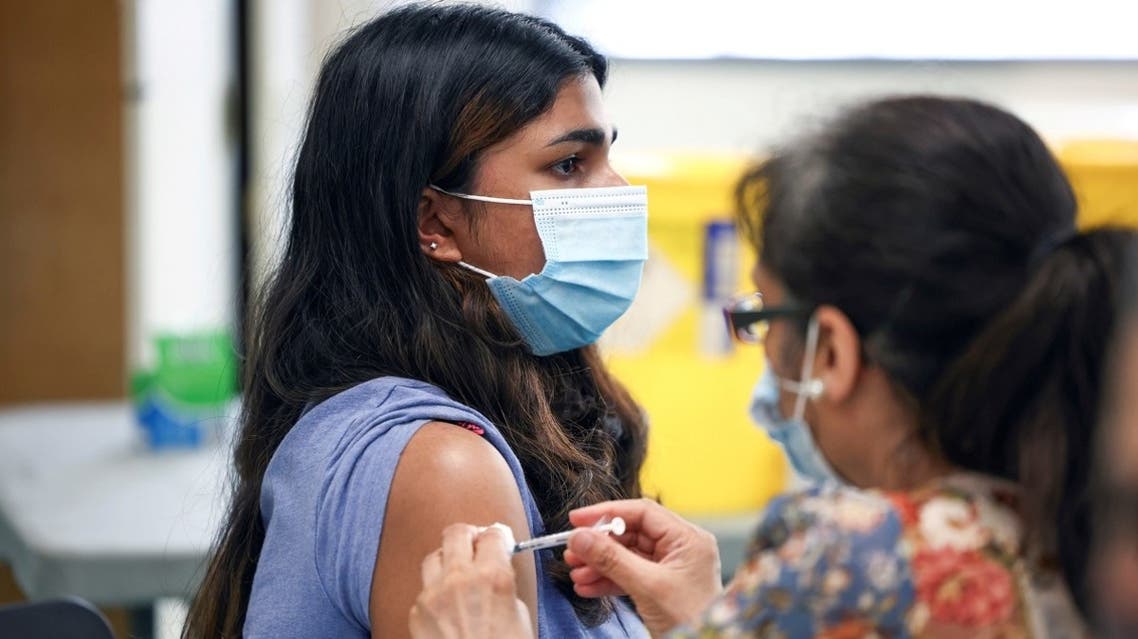A person receives a dose of the Pfizer BioNTech vaccine at a vaccination centre for those aged over 18 years old at the Belmont Health Centre in Harrow, amid the coronavirus outbreak in London, Britain, on June 6, 2021. (Reuters)