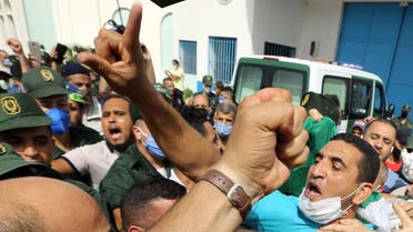 Activist Karim Tabbou flashes a victory sign as he is greeted by supporters as he is released from the prison of Kolea, west of Algiers, Algeria, on July 2, 2020. (AP)