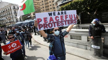 Demonstrators march with banners and flags during a protest demanding political change, in Algiers, Algeria April 9, 2021. (File Photo: Reuters)