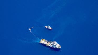 This handout picture shows two boats trying to contain an oil spill approaching eastern Corsica which appears to have leaked from a ship. (Florian Roussard/French Air Force/AFP)