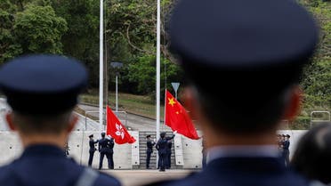 Police raise the Chinese national flag and the Hong Kong flag during an open day to mark National Security Education Day, at Hong Kong Police College, in Hong Kong, China, April 15, 2021. (Reuters)