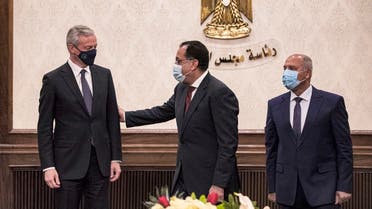 (L to R) France’s Economy and Finance Minister Bruno Le Maire, Egypt’s PM Mostafa Madbouli, and Egyptian Minister of Transportation Kamel el-Wazir at the prime minister’s office in Cairo, Egypt on June 13, 2021. (Khaled Desouki/AFP)