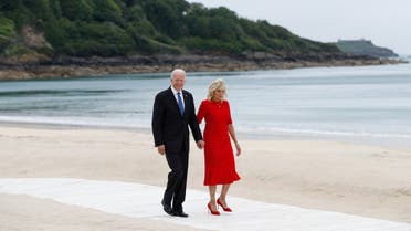 US President Joe Biden (L) and US First Lady Jill Biden walk along the path by the beach during the G7 summit in Carbis Bay, Cornwall, south-west England on June 11, 2021.