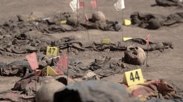 This aerial view taken on June 13, 2021, shows human remains, reportedly of victims of the 2014 Badush prison massacre committed by the Islamic State (IS) group, after being unearthed from a mass grave in the northern Iraqi village of Badush, northwest of the city of Mosul. In June 2014, IS fighters attacked the prison, freeing Sunnis and loading the remaining 600 mainly Shiite inmates onto trucks, before driving them to a ravine and shooting them.