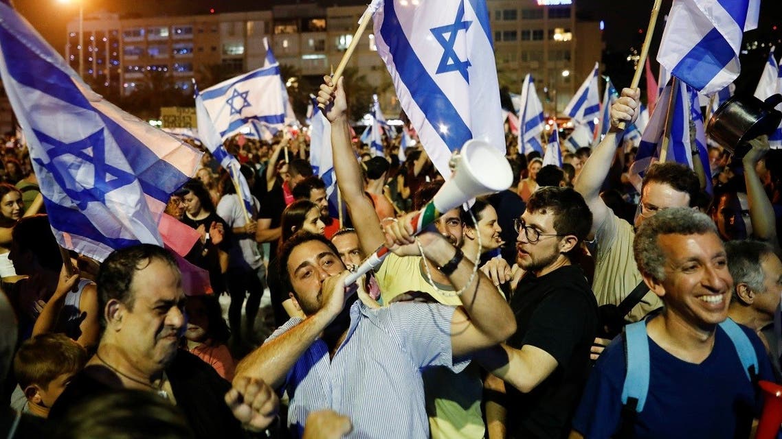 People celebrate after Israel's parliament voted in a new coalition government, ending Benjamin Netanyahu's 12-year hold on power, at Rabin Square in Tel Aviv, Israel. (Reuters)