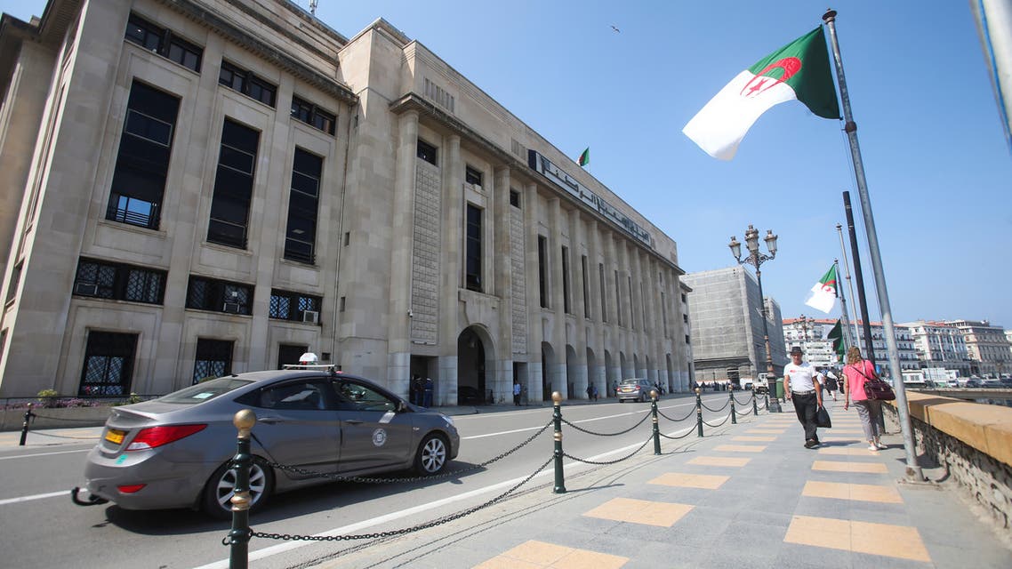 People walk past the building of the lower parliament chamber in Algiers, Algeria September 16, 2020. Picture taken September 16, 2020. (Reuters)