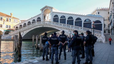 Police officers wait for the demonstration of merchants to arrive at Rialto bridge, as Italy begins a staged end to a nationwide lockdown due to a spread of the coronavirus disease (COVID-19), in Venice, Italy, May 4, 2020. (Reuters)