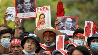 Demonstrators hold placards with pictures of Aung San Suu Kyi as they protest against the military coup in Yangon, Myanmar, February 22, 2021. REUTERS/Stringer